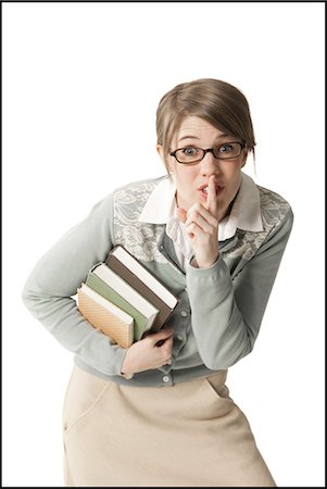 female professors - Woman holding books with finger to lips Stock Photo - Premium Royalty-Free, Code: 640-03260045