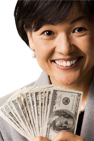 prosper - Closeup of woman holding US banknotes Stock Photo - Premium Royalty-Free, Code: 640-03260702