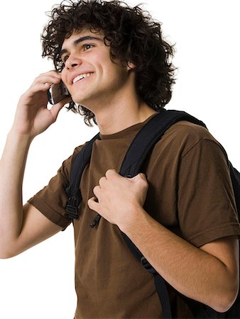 simsearch:640-03260747,k - Teenage boy talking on cell phone holding backpack Stock Photo - Premium Royalty-Free, Code: 640-03260744