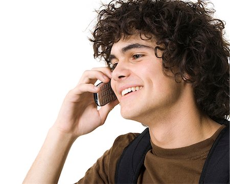 simsearch:640-03260747,k - Teenage boy talking on cell phone holding backpack Stock Photo - Premium Royalty-Free, Code: 640-03260746
