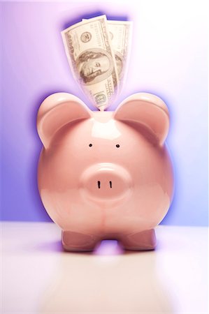 Pink piggy bank with dollar bills Stock Photo - Premium Royalty-Free, Code: 640-03260791