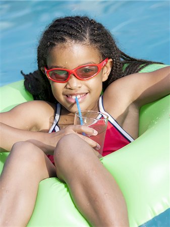 Girl on pool lounger with pink lemonade Stock Photo - Premium Royalty-Free, Code: 640-03261009