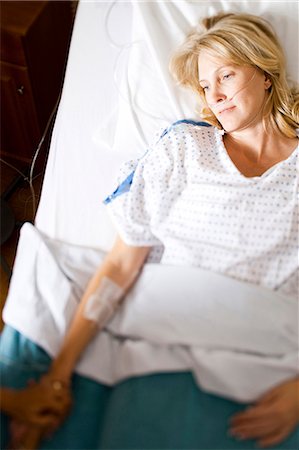 Woman sleeping in hospital bed Stock Photo - Premium Royalty-Free, Code: 640-03261380