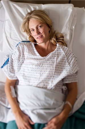 Woman sleeping in hospital bed Stock Photo - Premium Royalty-Free, Code: 640-03261382