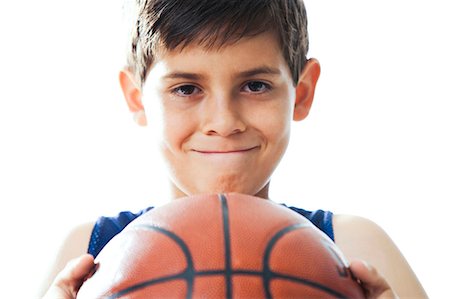 Boy sitting on basketball Stock Photo - Premium Royalty-Free, Code: 640-03261634