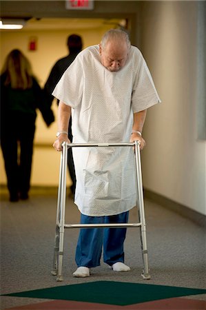 Mature man in hospital gown with walker Stock Photo - Premium Royalty-Free, Code: 640-03261775