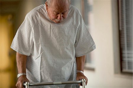 Mature man in hospital gown with walker Stock Photo - Premium Royalty-Free, Code: 640-03261776