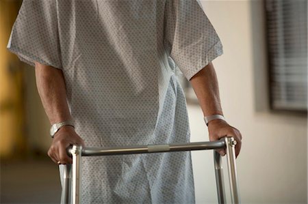 Mature man in hospital gown with walker Stock Photo - Premium Royalty-Free, Code: 640-03261777