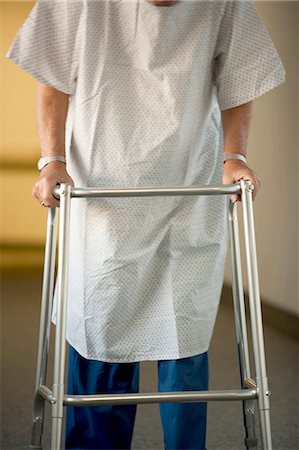 Mature man in hospital gown with walker Stock Photo - Premium Royalty-Free, Code: 640-03261771