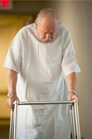 Mature man in hospital gown with walker Stock Photo - Premium Royalty-Free, Code: 640-03261772