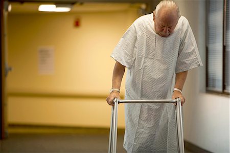 Mature man in hospital gown with walker Stock Photo - Premium Royalty-Free, Code: 640-03261773