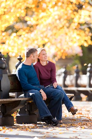 Couple sitting on wooden bench outdoors Stock Photo - Premium Royalty-Free, Code: 640-03261906