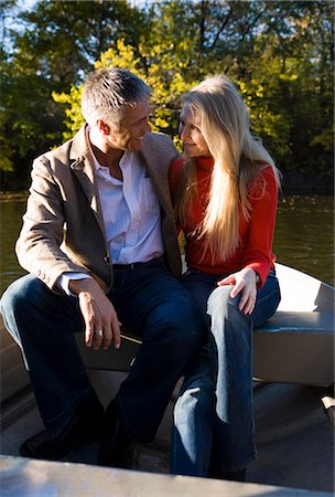 Couple sitting by water Stock Photo - Premium Royalty-Free, Code: 640-03261944