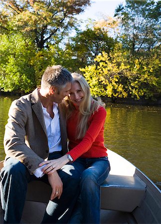 Couple sitting by water Stock Photo - Premium Royalty-Free, Code: 640-03261945
