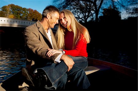 Couple sitting by water Stock Photo - Premium Royalty-Free, Code: 640-03261953