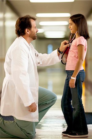 patient doctor hall - Young girl playing with female doctor's stethoscope Stock Photo - Premium Royalty-Free, Code: 640-03261975