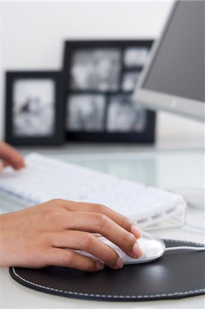Female hand on mouse with keyboard Stock Photo - Premium Royalty-Free, Code: 640-03261984