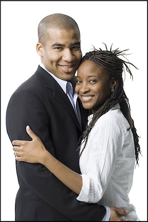 executive standing white background - Closeup of couple smiling Stock Photo - Premium Royalty-Free, Code: 640-03262084