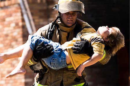 rescue - Fire fighter rescuing child Stock Photo - Premium Royalty-Free, Code: 640-03262118