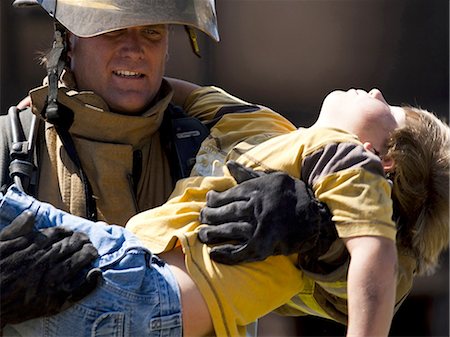 rescue - Fire fighter rescuing child Stock Photo - Premium Royalty-Free, Code: 640-03262122