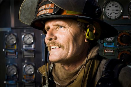firefighter rescue truck - Portrait of a firefighter in front of control panel Stock Photo - Premium Royalty-Free, Code: 640-03262173