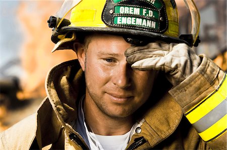 rescue - Portrait of a firefighter with fire in background Stock Photo - Premium Royalty-Free, Code: 640-03262199