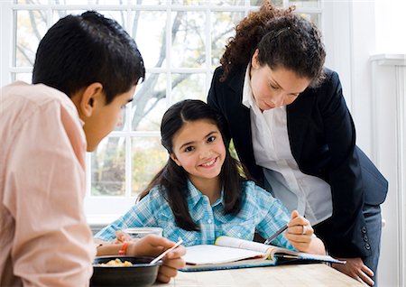 school mother and child - Girl doing homework with woman watching Stock Photo - Premium Royalty-Free, Code: 640-03262670