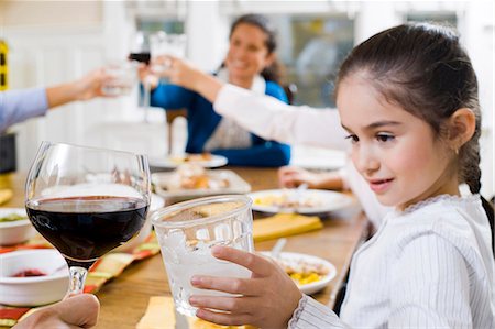 saluting - Family at dinner table toasting Stock Photo - Premium Royalty-Free, Code: 640-03262710