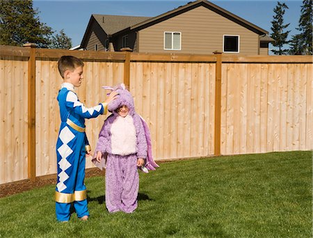 Girl and boy in yard in halloween costumes Stock Photo - Premium Royalty-Free, Code: 640-03262784