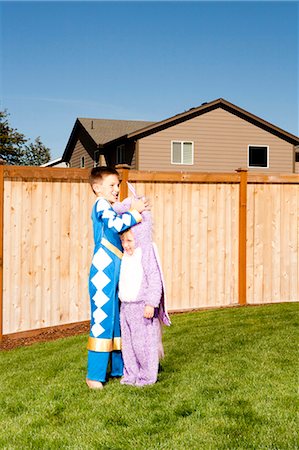 Girl and boy in yard in halloween costumes Stock Photo - Premium Royalty-Free, Code: 640-03262785