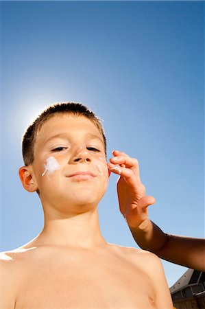Boy with suntan lotion shouting Stock Photo - Premium Royalty-Free, Code: 640-03262793