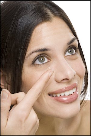 Closeup of woman inserting contact lens Stock Photo - Premium Royalty-Free, Code: 640-03262919