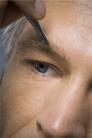 pluck - Closeup of man with tweezers plucking eyebrows Stock Photo - Premium Royalty-Free, Code: 640-03262973