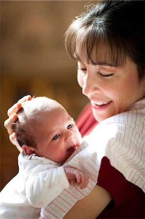 Woman holding newborn Stock Photo - Premium Royalty-Free, Code: 640-03263093