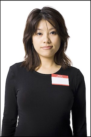 Portrait of a woman with blank name tag Stock Photo - Premium Royalty-Free, Code: 640-03263121