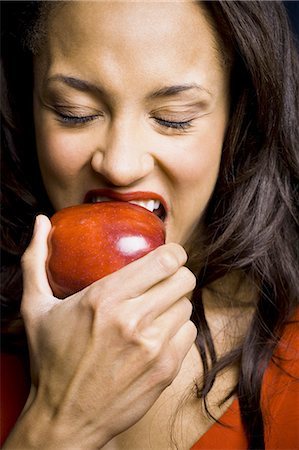 Woman eating red apple Stock Photo - Premium Royalty-Free, Code: 640-03263169
