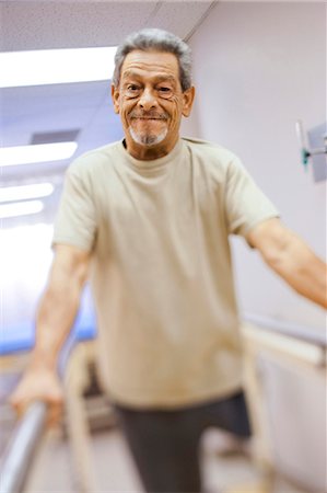 physical - Older man with one leg exercising and smiling Stock Photo - Premium Royalty-Free, Code: 640-03263204