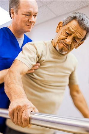 elderly excercising - Physical Therapist holding a patient while walking Stock Photo - Premium Royalty-Free, Code: 640-03263215