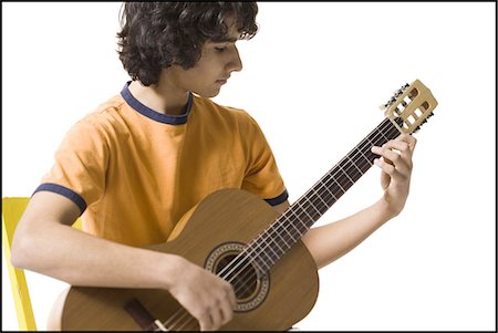 Boy playing the guitar Foto de stock - Sin royalties Premium, Código: 640-03263386