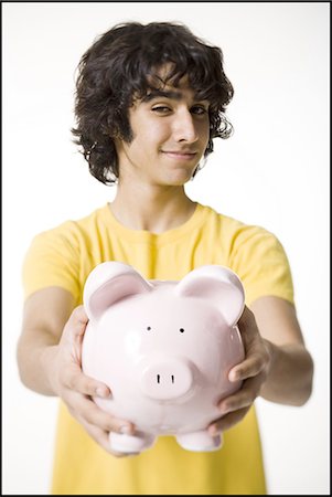 Boy holding a piggy bank Stock Photo - Premium Royalty-Free, Code: 640-03263424