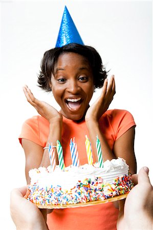 party hat - Woman receiving a birthday cake Stock Photo - Premium Royalty-Free, Code: 640-03263677