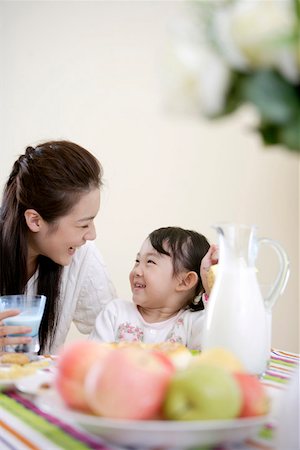 flower for mom asian - Mother sitting with daughter at breakfast table Stock Photo - Premium Royalty-Free, Code: 642-01734251