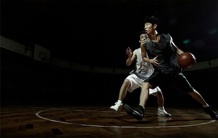 Two young men playing basketball Stock Photo - Premium Royalty-Free, Code: 642-01735991