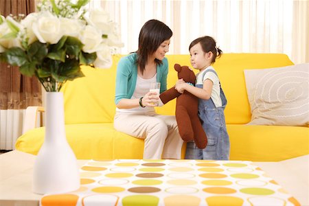 flower for mom asian - Mother and daughter with doll and a glass of milk Stock Photo - Premium Royalty-Free, Code: 642-01736918