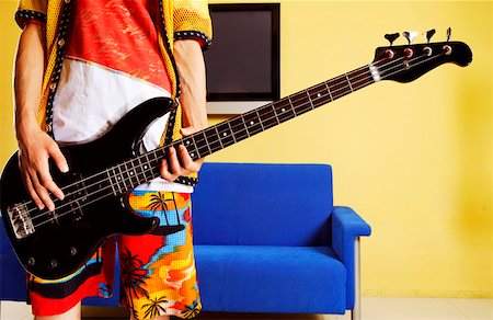picture of the blue playing a instruments - Fashionable young man playing guitar Stock Photo - Premium Royalty-Free, Code: 642-01737624