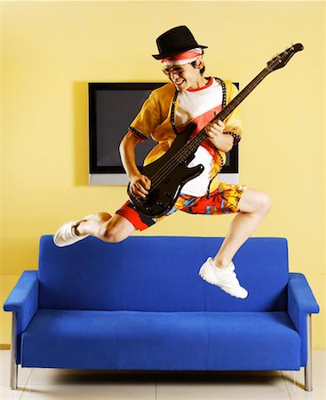 picture of the blue playing a instruments - Fashionable young man jumping and playing guitar Stock Photo - Premium Royalty-Free, Code: 642-01737622