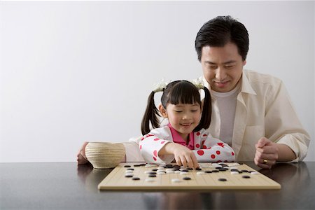 Father and daughter playing I-go Stock Photo - Premium Royalty-Free, Code: 642-01732847