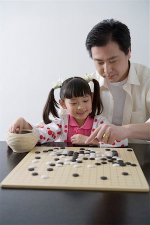 Father and daughter playing I-go Stock Photo - Premium Royalty-Free, Code: 642-01732857