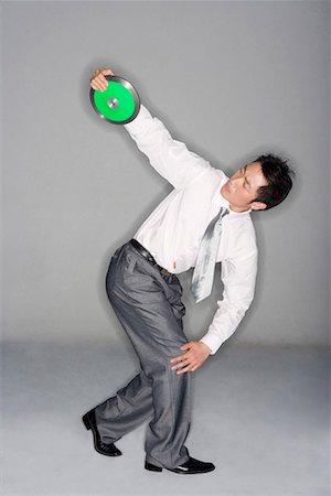 full body cast - a man in business suit throwing discus Stock Photo - Premium Royalty-Free, Code: 642-02005080