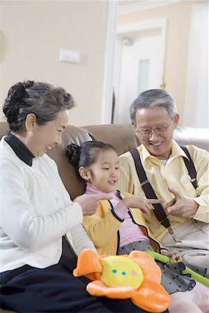 simsearch:642-02005954,k - an old couple and their granddaughter an old couple and their granddaughter,playing a finger-guessing game Stock Photo - Premium Royalty-Free, Code: 642-02005956